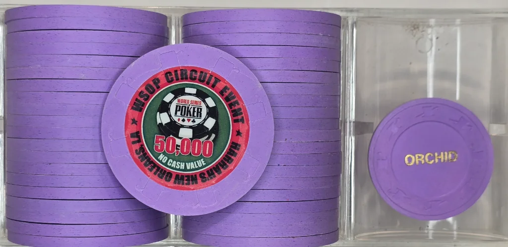 40 Harrah's New Orleans 48mm WSOP T50,000 solid chips.  Paulson Fat Hat and Cane orchid chips. Chips are in like new condition.