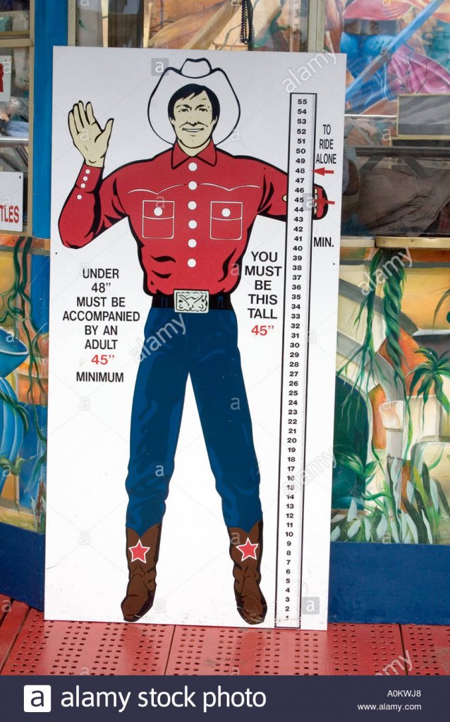 sign-showing-how-tall-a-child-must-be-to-ride-a-carnival-ride-at-the-A0KWJ8.jpg