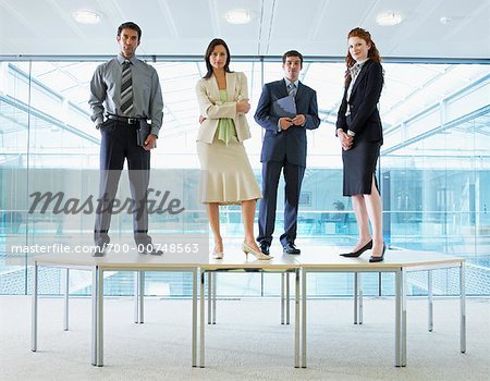 700-00748563em-portrait-of-business-people-standing-on-boardroom-table.jpg